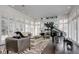 Bright living room featuring a grand piano, plantation shutters, and a zebra rug at 52 Sedgwick Dr, Cherry Hills Village, CO 80113