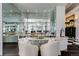 Elegant wet bar with mirrored backsplash and seating for two at 52 Sedgwick Dr, Cherry Hills Village, CO 80113