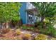 Landscaped front yard with walkway leading to charming blue home at 9075 E 36Th Ave, Denver, CO 80238