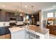 Modern kitchen with white and dark gray cabinets and an island at 9075 E 36Th Ave, Denver, CO 80238