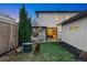 A well-manicured backyard featuring a modern fire pit area and an outdoor living space with a pergola at 1518 S Columbine St, Denver, CO 80210