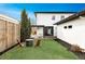 A well-manicured backyard featuring a modern fire pit area and an outdoor living space with a pergola at 1518 S Columbine St, Denver, CO 80210
