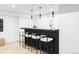 Stylish wet bar area featuring modern pendant lighting and bar seating for entertaining guests in comfort at 1518 S Columbine St, Denver, CO 80210