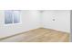 Clean, bright basement bedroom features a minimalist design and window well for light and ventilation at 1518 S Columbine St, Denver, CO 80210