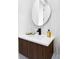 Modern bathroom vanity with unique round mirror, sleek fixtures, and stylish lighting for a contemporary look at 1518 S Columbine St, Denver, CO 80210