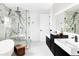 Contemporary bathroom features dual vanities, a soaking tub and a marble accented glass enclosed shower at 1518 S Columbine St, Denver, CO 80210