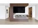 Modern entertainment center featuring a large TV, sleek wood paneling, and stylish bar seating at 1518 S Columbine St, Denver, CO 80210