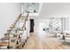 Bright, modern entryway with floating wood stairs, glass railings, and open-concept living space at 1518 S Columbine St, Denver, CO 80210