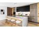 Spacious kitchen with sleek cabinetry, a waterfall island with seating, modern lighting, and stainless steel appliances at 1518 S Columbine St, Denver, CO 80210