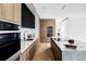 Modern kitchen with a waterfall island, sleek countertops, stainless steel appliances, and custom cabinetry at 1518 S Columbine St, Denver, CO 80210