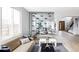 Open-concept living room with modern decor, natural light, and a unique glass wine display feature at 1518 S Columbine St, Denver, CO 80210