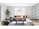 Bright and airy living room featuring modern furnishings, a large window, and a striking glass wine display at 1518 S Columbine St, Denver, CO 80210