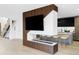 Modern living room featuring a fireplace, television, wood slat decor, and open concept design, steps away from a floating staircase at 1518 S Columbine St, Denver, CO 80210