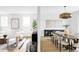 Open-concept living room and dining room with modern furnishings and decor and lots of natural light at 1518 S Columbine St, Denver, CO 80210