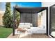 Outdoor living space with stylish pergola, modern furniture, and wood deck, creating a relaxing and inviting backyard retreat at 1518 S Columbine St, Denver, CO 80210