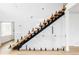 Modern staircase with wood treads and glass railing, offering a sleek and open design at 1518 S Columbine St, Denver, CO 80210