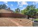 Backyard featuring a garden area with brick path and mature landscaping at 16563 E Kansas Pl, Aurora, CO 80017