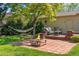 Serene backyard with brick patio, firepit, hammock, mature tree and outdoor seating at 16563 E Kansas Pl, Aurora, CO 80017