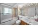 Bathroom featuring tub and shower combo with glass doors, and vanity with sink at 16563 E Kansas Pl, Aurora, CO 80017
