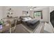 Inviting bedroom with a tufted headboard bed, desk, and soft natural light at 16563 E Kansas Pl, Aurora, CO 80017