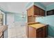 Bright kitchen with wood cabinets, tile counters, and a breakfast bar area at 16563 E Kansas Pl, Aurora, CO 80017
