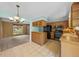 Bright kitchen with tile floors, oak cabinetry, black appliances and natural light at 16563 E Kansas Pl, Aurora, CO 80017