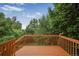 A wood deck provides a relaxing outdoor space amidst lush trees and greenery at 611 Branding Iron Ln, Castle Rock, CO 80104