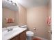 Cozy half bath with a pedestal sink and warm neutral tones at 611 Branding Iron Ln, Castle Rock, CO 80104