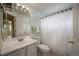 Clean bathroom with a white vanity, toilet, and shower with curtain at 611 Branding Iron Ln, Castle Rock, CO 80104