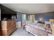Spacious bedroom with wall paneling, carpet, large dresser and access to ensuite bathroom at 611 Branding Iron Ln, Castle Rock, CO 80104