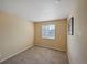 This bedroom features neutral walls, plush carpeting, and a window offering natural light at 611 Branding Iron Ln, Castle Rock, CO 80104