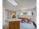 Open dining area with chandelier, wood table, and views to another living space at 611 Branding Iron Ln, Castle Rock, CO 80104