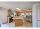 Bright kitchen with light wood cabinets, stainless steel appliances, and a functional island at 611 Branding Iron Ln, Castle Rock, CO 80104