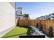 Landscaped backyard with artificial turf and a wooden fence at 6202 N Galena St, Denver, CO 80238