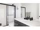 Spa-like bathroom with a walk-in shower, modern vanity, and black accents at 6202 N Galena St, Denver, CO 80238