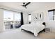 Bright bedroom with sliding glass door to balcony and ceiling fan at 6202 N Galena St, Denver, CO 80238