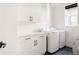 Bright laundry room with white cabinets and modern washer and dryer at 6202 N Galena St, Denver, CO 80238