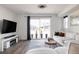 Bright living room with modern furniture and sliding glass doors leading to backyard at 6202 N Galena St, Denver, CO 80238