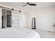 Main bedroom with barn door to ensuite and large mirror at 6202 N Galena St, Denver, CO 80238