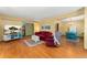 Bright living room showcasing hardwood floors, fireplace, tv, a cozy sitting area, and a dining space at 4390 S Sheridan Blvd, Littleton, CO 80123