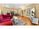 Inviting living room featuring hardwood floors, a fireplace, large windows with shutters, and a comfortable seating area at 4390 S Sheridan Blvd, Littleton, CO 80123