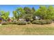 Image of a lush lawn surrounded by bushes and mature trees providing privacy and a peaceful setting at 4390 S Sheridan Blvd, Littleton, CO 80123