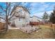 A charming backyard with a brick patio, lawn, and mature trees creates a private outdoor space at 9864 S Garland Ct, Littleton, CO 80127