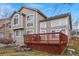 The backyard features a spacious wood deck perfect for entertaining with views of the manicured lawn at 9864 S Garland Ct, Littleton, CO 80127