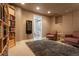 Finished basement area with built-in shelving and access to a bathroom at 9864 S Garland Ct, Littleton, CO 80127