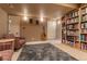 Finished basement features a large bookshelf and comfortable seating area at 9864 S Garland Ct, Littleton, CO 80127