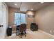 Finished basement includes a window and desk with a carpeted floor at 9864 S Garland Ct, Littleton, CO 80127