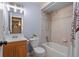 Bathroom featuring neutral walls, tile surround, and a shower-tub combo at 9864 S Garland Ct, Littleton, CO 80127