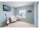 Bedroom features neutral carpet and a window with views of the neighborhood at 9864 S Garland Ct, Littleton, CO 80127