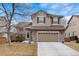 Charming two-story home with a well-maintained lawn and two-car garage at 9864 S Garland Ct, Littleton, CO 80127